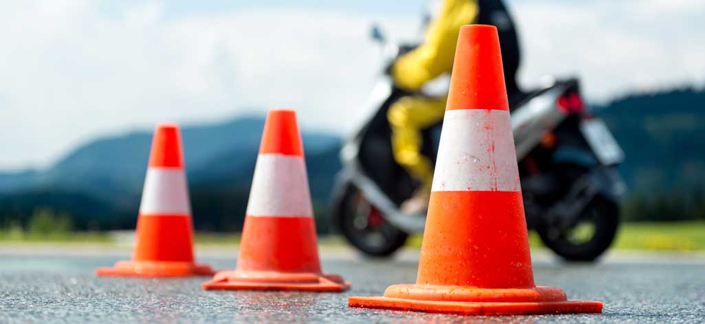 motorcycle rider avoiding traffic cones