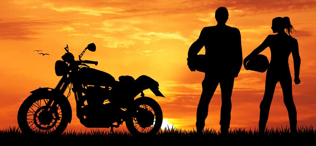 motorcycle rider admiring sunset with partner